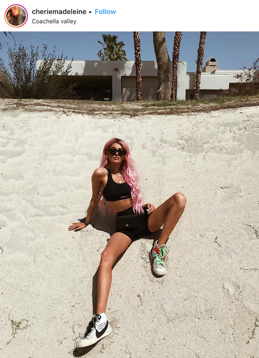 Cherie Madeline Instagram post at Coachella with neon pink hair