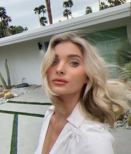 Young woman with freshly styled creamy blonde hair in the wind